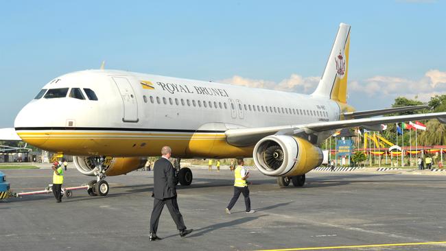 Former NT Chief Minister Paul Henderson, front, pictured with a Royal Brunei jet