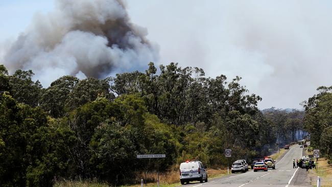 A fatal car crash has sparked an out of control bush fire south of Kurri Kurri at Pelaw Main. Picture: Peter Lorimer.