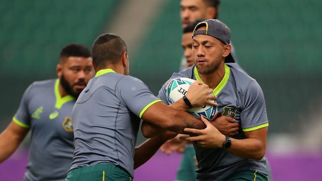 Christian Lealiifano is tackled by Kurtley Beale during the Wallabies Captain's Run ahead of their 2019 Rugby World Cup quarter-final against England at Oita Stadium. Picture: Getty Images