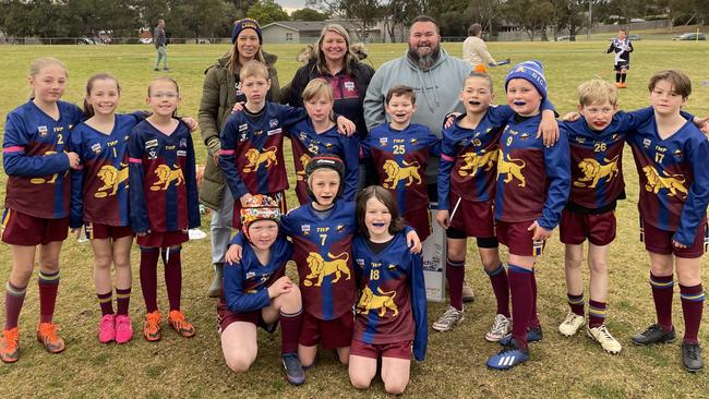 Michelle Mahoney, centre with under-10 Belmont Lions football team manager Sarah Henderson, husband and co-coach Ashley and the team during a club fundraiser, Roar for the Mahoney’s, as she battles breast cancer.