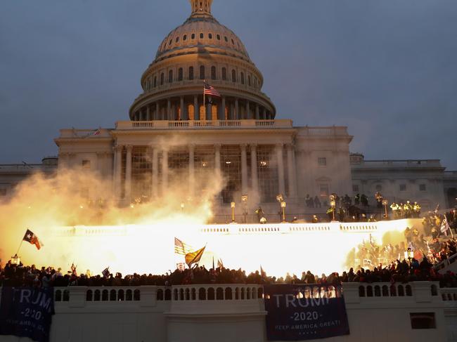 An explosion caused by a police munition is seen while Trump supporters gather in front of the US Capitol building in Washington. Picture: Reuters