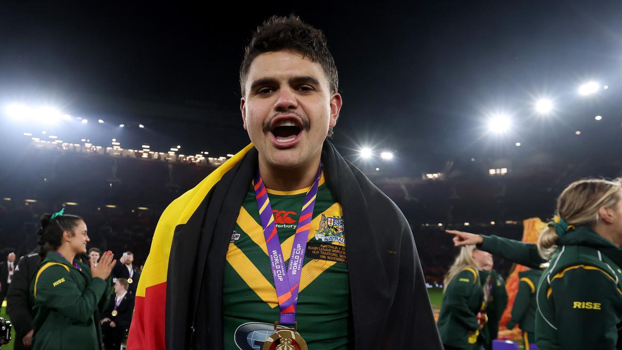 MANCHESTER, ENGLAND - NOVEMBER 19: Latrell Mitchell of Australia celebrates with their Rugby League World Cup winners medal while draped in the Aboriginal flag following the Rugby League World Cup Final match between Australia and Samoa at Old Trafford on November 19, 2022 in Manchester, England. (Photo by George Wood/Getty Images)