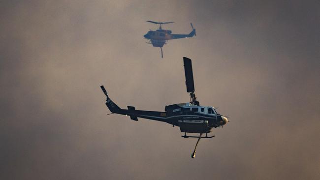 Water bombing helicopters helping to fight the fire in Landsborough late on Sunday afternoon. Picture Lachie Millard