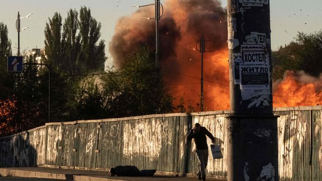 A man falls is seen on the ground after a blast following a drone attack in Kyiv. Picture: AFP