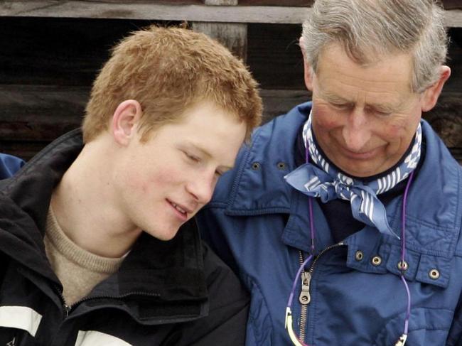 Harry and Charles share a tender moment at a Swiss ski resort in 2005. Picture: PASCAL LE SEGRETAIN/GETTY IMAGES/The Times