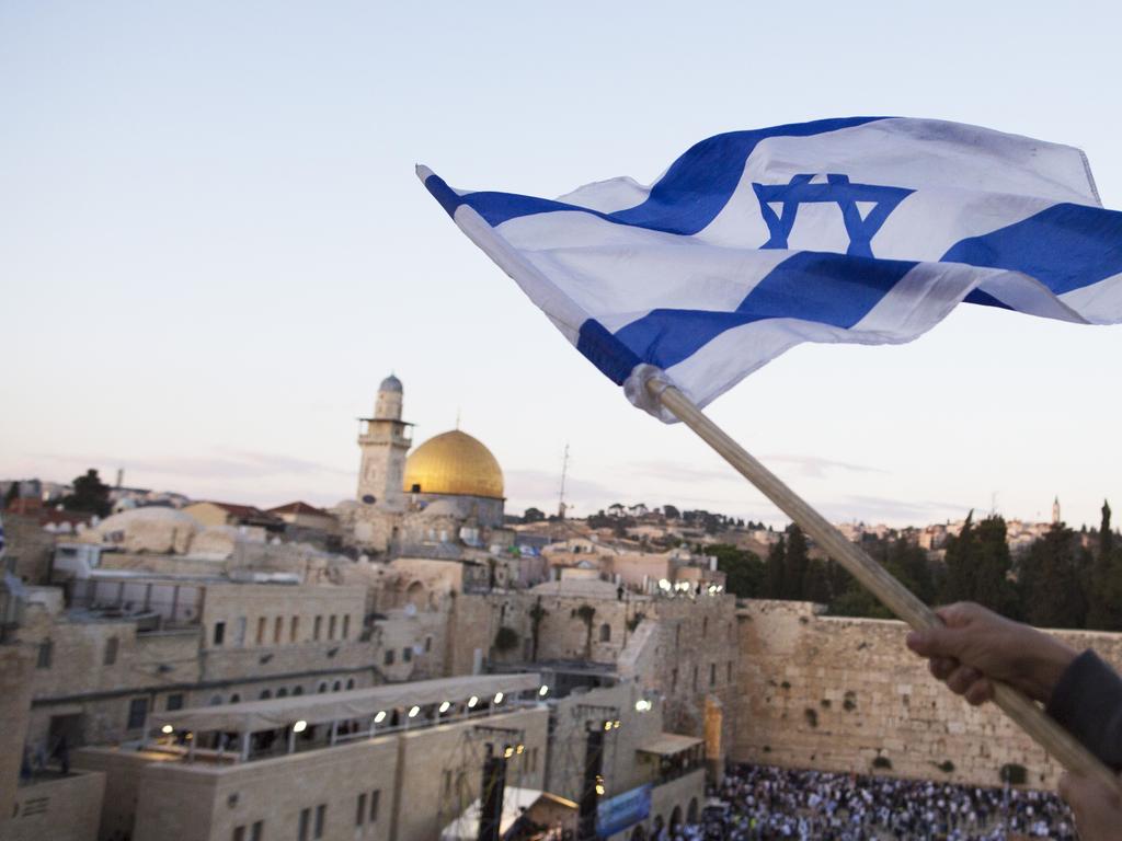 Israelis wave their national flags during a march next to the Western Wall. Picture: Getty