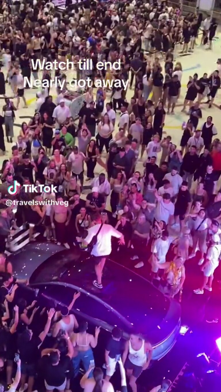 The man dances on top of a luxury car. Picture: Supplied / TikTok