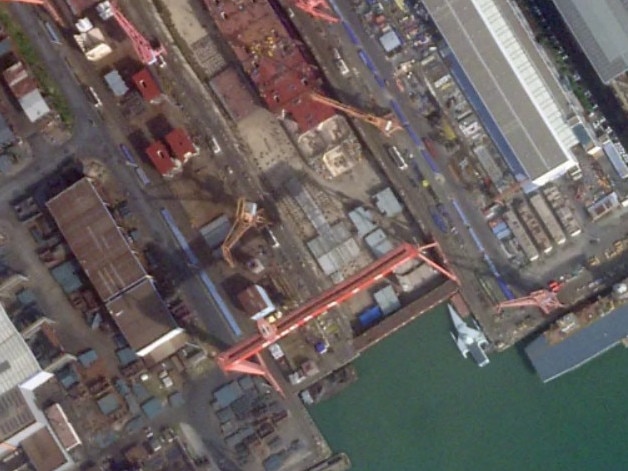 A satellite image of Guangzhou Shipyard International taken on October 23, 2024, showing, among other things, what looks to be a new class of Chinese ship with a large flight deck. PHOTO © 2024 PLANET LABS INC.