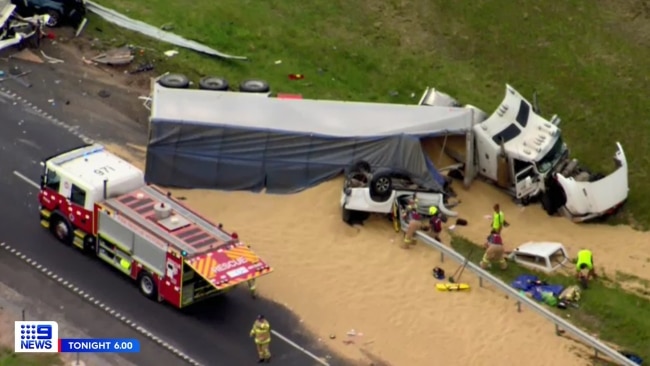 Grain spilled from the truck after crashing into the cars and ploughing through a metal barrier. The truck driver is in police custody and assisting police with their inquiries. Picture: Channel 9