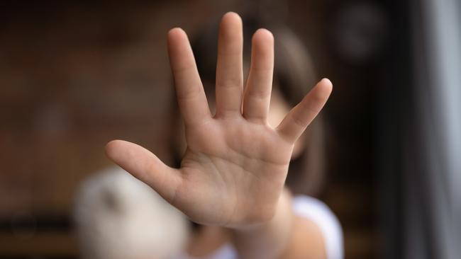 Crop close up of little girl child stretch hand show no gesture protest against domestic violence. Small teen child stand against discrimination or school abuse. Childhood problem, voice concept.