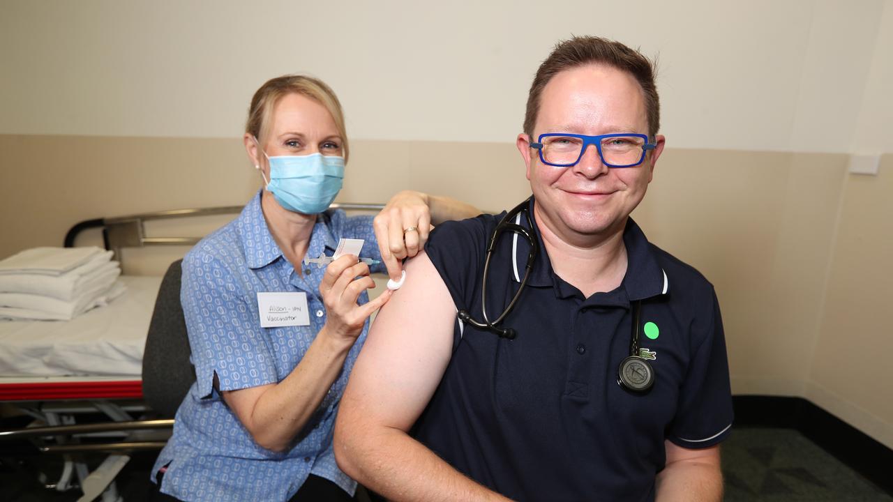 Alison Clancy a nurse injects Associate Professor Paul Griffin, an infectious disease expert, with the AstraZeneca vaccine. Picture: Annette Dew