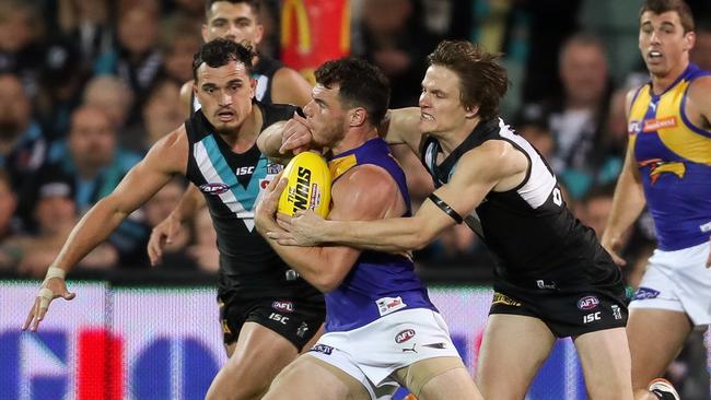 Luke Shuey is tackled by Jared Polec. Picture: AFL Media/Getty Images.