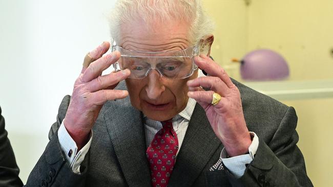 The king puts on some safety glasses during his visit to the cancer research centre at Ulster University in Belfast. Picture: Getty