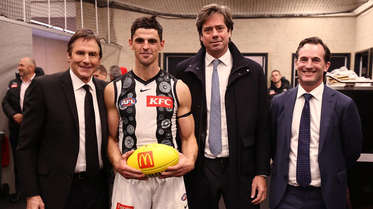 Scott Pendlebury of the Magpies receives the match ball from AFL CEO Gillon McLachlan, Andrew Dillon and Collingwood president Jeff Browne after breaking the games possession record. Picture: Michael Klein