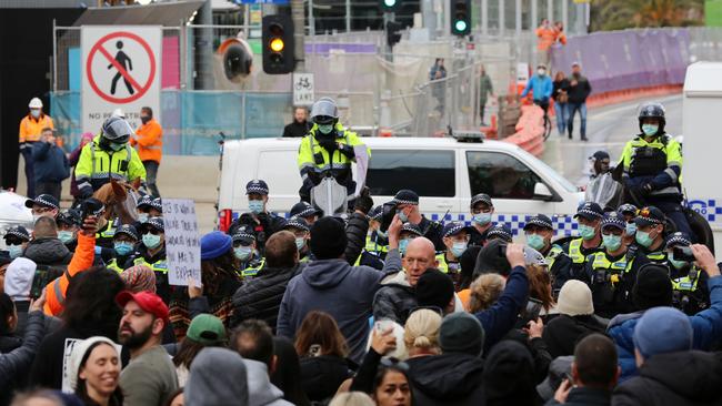 Hundreds of protesters at the intersection outside Flinders St Station.