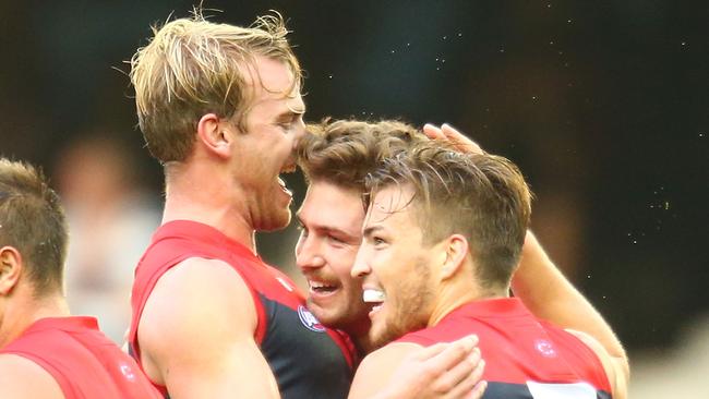 Tomas Bugg with Jack Viney of the Demons and Jack Watts kicking a goal. (Photo by Scott Barbour/Getty Images)