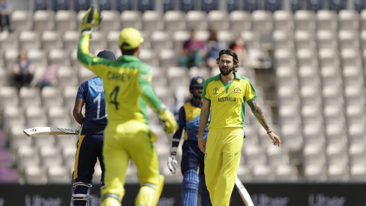 Australia's Kane Richardson, right, celebrates taking the wicket of Sri Lanka captain Dimuth Karunaratne, left, caught by Australian keeper Alex Carey in Southampton. Picture: Matt Dunham.