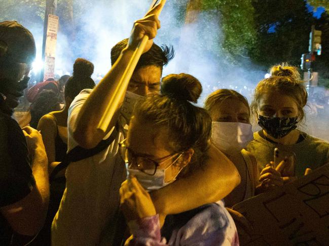 Demonstrators run from the tear gas outside of the White House in Washington, D.C. Picture: AFP