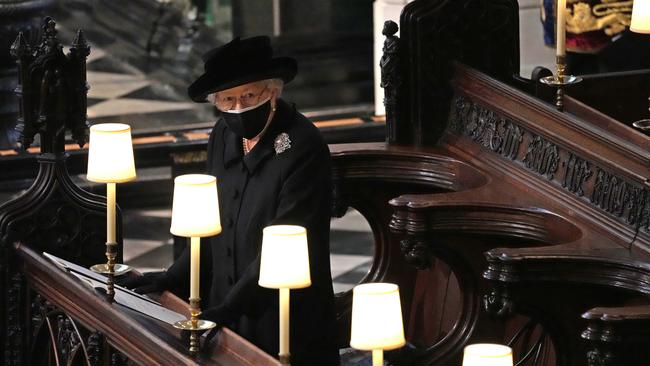 Queen Elizabeth II watches as pallbearers carry the coffin of Prince Philip.