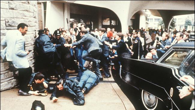 Police &amp; Secret Service agents reacting during the assassination attempt on then-US president Ronald Reagan outside the Hilton Hotel in Washington on March 30, 1981.