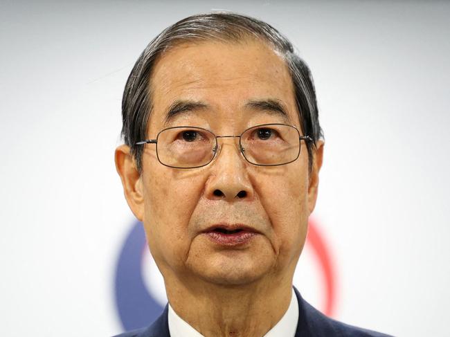 South Korea Prime Minister and acting President Han Duck-soo speaks in his address to the nation at the Government Complex in Seoul on December 26, 2024. South Korea's opposition said on December 26 it had filed an impeachment motion against acting president Han Duck-soo, after he refused to appoint Constitutional Court judges to complete the process of removing his predecessor from office. (Photo by YONHAP / AFP) / - South Korea OUT / NO ARCHIVES -  RESTRICTED TO SUBSCRIPTION USE