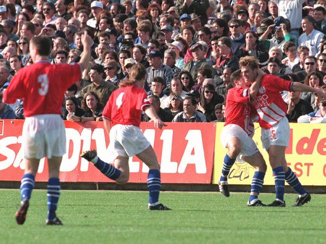 Andrew Marth (R) is hugged my teammate Mark Silic after scoring the opener in the 1995 NSL grand final, as David Cervinski (no. 4) and Fausto De Amicis (no. 3) join in to celebrate.