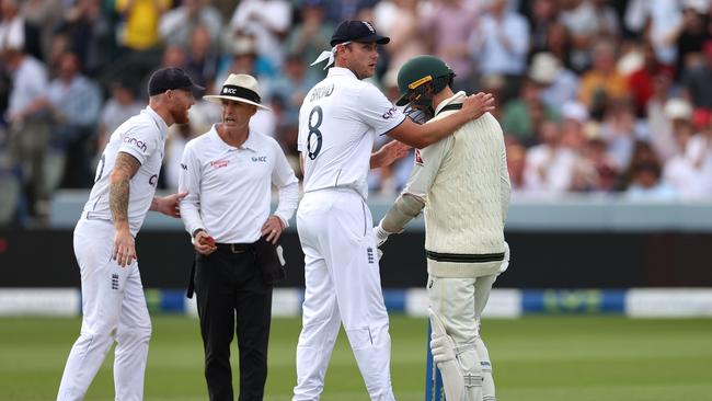 An injured Nathan Lyon (R) speaks with England veteran Stuart Broad. Picture: Getty