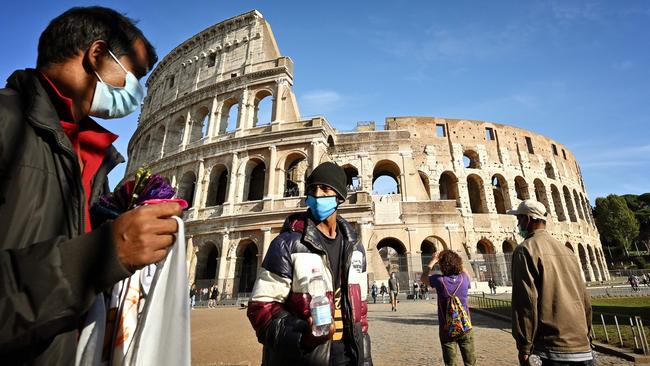 Street vendors ply their trade on a quiet day at The Colosseum in Rome last week. AFP