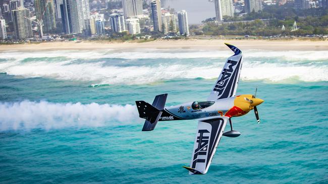 Pacific Airshow - Gold Coast 2024. Stunt pilot Matt Hall in his MXS-R flies over the Gold Coast skyline ahead of the Pacific Airshow. Picture: Nigel Hallett