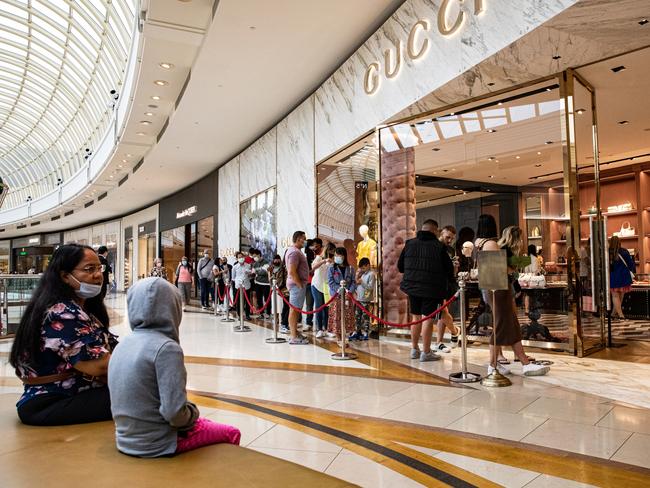 MELBOURNE, AUSTRALIA - DECEMBER 26: Shoppers line up outside Gucci at Chadstone The Fashion Capital during the Boxing Day sales on December 26, 2021 in Melbourne, Australia. Australians celebrate Boxing Day with many taking advantage of the post-Christmas sale prices in what is usually the busiest day of the year for retailers in Australia. In Sydney, thousands of people usually gather around and on the harbour to watch the start of the Sydney to Hobart yacht race. (Photo by Diego Fedele/Getty Images)