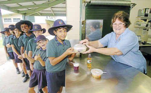 Lining up for some healthy food are (from left) Uvin Seneviratne, Charlie Cummings, Joel Pearson, Amjad Aslam, Ella Cummings, Emily Shiels and Shayne Tobias, greeted by tuckshop convenor Merle Finnis. Picture: Mike Knott