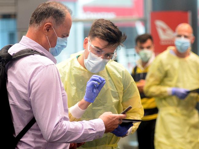 Passengers from Qantas Flight arriving from Perth at Sydney are screened by NSW Health before entering quarantine. Photo Jeremy Piper