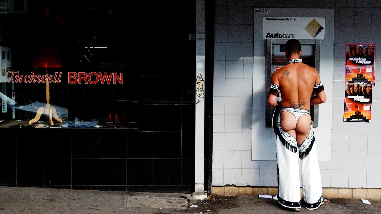 A Mardi Gras reveller withdraws money from an ATM for the cab fare home after partying all night. Picture: Dean Lewins/AAP