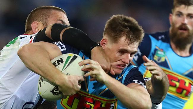 GOLD COAST, AUSTRALIA — JULY 15: Alexander Brimson of the Titans is tackled during the round 18 NRL match between the Gold Coast Titans and the Sydney Roosters at Cbus Super Stadium on July 15, 2018 in Gold Coast, Australia. (Photo by Chris Hyde/Getty Images)