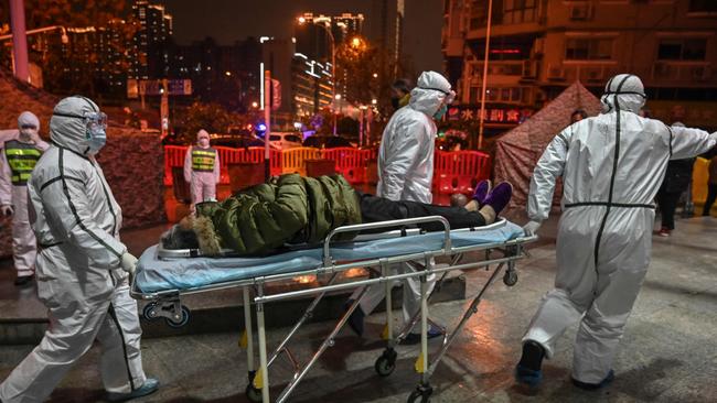 Medical staff members wearing protective clothing to help stop the spread of a deadly virus which began in the city, arrive with a patient at the Wuhan Red Cross Hospital in Wuhan on January 25, 2020. Picture: Hector Retamal/AFP