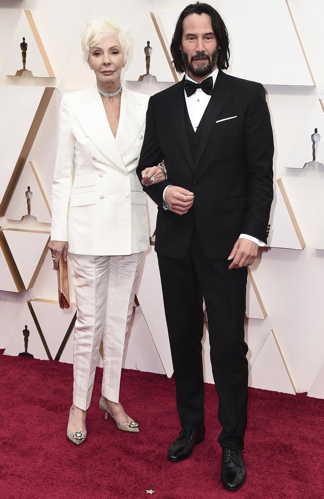 Patricia Taylor and Keanu Reeves arrive at the Oscars. Picture: Jordan Strauss/Invision/AP