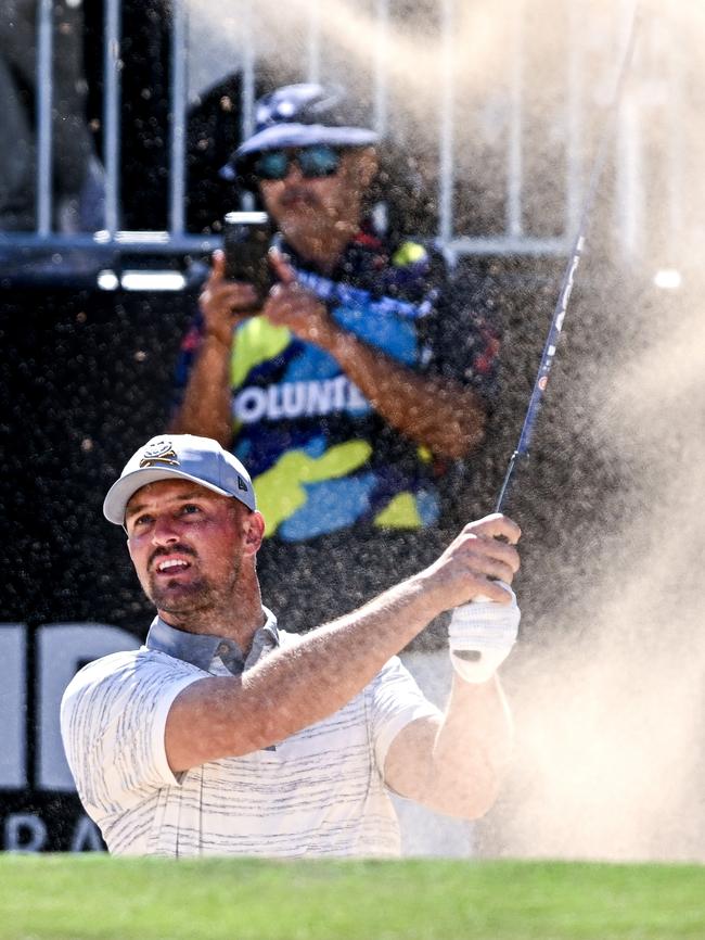 Bryson Dechambeau hits out of a bunker. Picture: Mark Brake