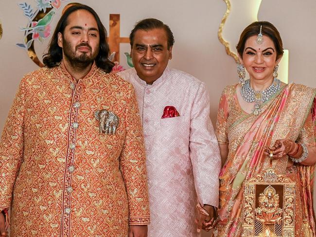 The groom posed with his parents, Mukesh and Nita Ambani, on the wedding’s red carpet. Picture: Punit Paranjpe/AFP