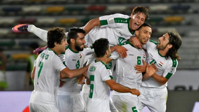 Iraq's defender Ali Adnan (2nd-R) celebrates after scoring a goal during the 2019 AFC Asian Cup group D football match between Iraq and Vietnam at Zayed Sports City stadium in Abu Dhabi on January 8, 2019. (Photo by Khaled DESOUKI / AFP)