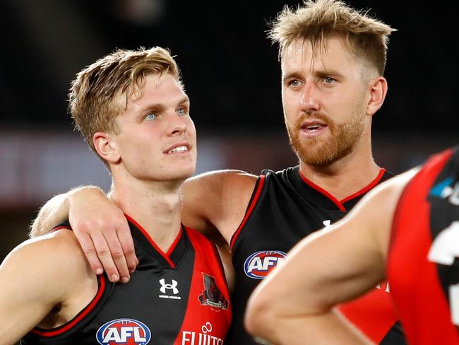 MELBOURNE, AUSTRALIA - APRIL 17: Ben Hobbs and Dyson Heppell of the Bombers look dejected after a loss during the 2022 AFL Round 05 match between the Essendon Bombers and the Fremantle Dockers at Marvel Stadium on April 17, 2022 In Melbourne, Australia. (Photo by Dylan Burns/AFL Photos via Getty Images)