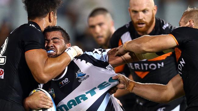 Andrew Fifita of the Sharks is tackled by the Tigers defence during the NRL Trial Match between the Wests Tigers and the Cronulla Sharks at Campbelltown Sports Stadium on February 21.  (Photo by Renee McKay/Getty Images)