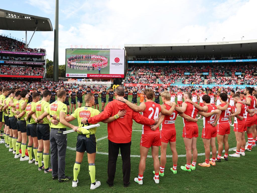 Sydney Swans and GWS Giants players, coaches and umpires form a circle as a show of support against gender based violence before their round eight AFL match on May 4. Picture: Matt King/AFL Photos via Getty Images