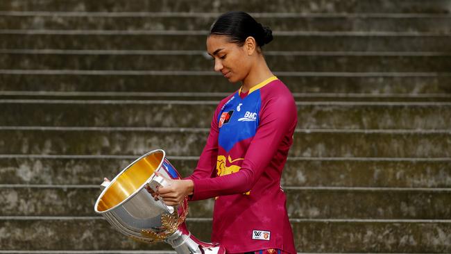 Brisbane Lions player Zimmorlei Farquharson likes the look of the AFLW trophy. Picture: Dylan Burns/AFL Photos via Getty Images