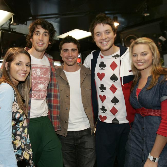 Radio hosts Hamish Blake and Andy Lee film a scene for TV show Neighbours at Fox FM Studios, St Kilda. (L to R) Caitlin Stasey (Neighbours actor), Andy Lee, Nick Anderson, Hamish Blake and Margot Robbie (Neighbours actor).