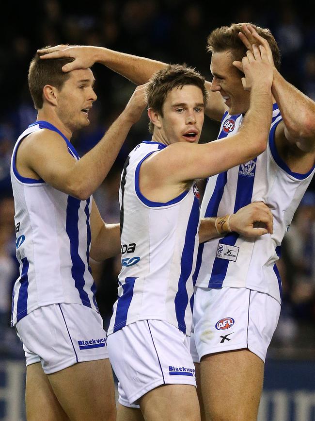 Bastinac celebrates a goal with McKenzie and Drew Petrie.