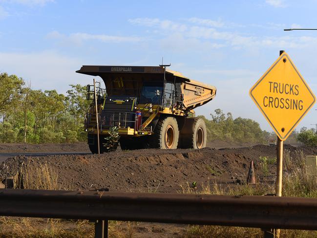 A haul truck drives past a crossing at South32's GEMCO manganese mining operation on Groote Eylandt.