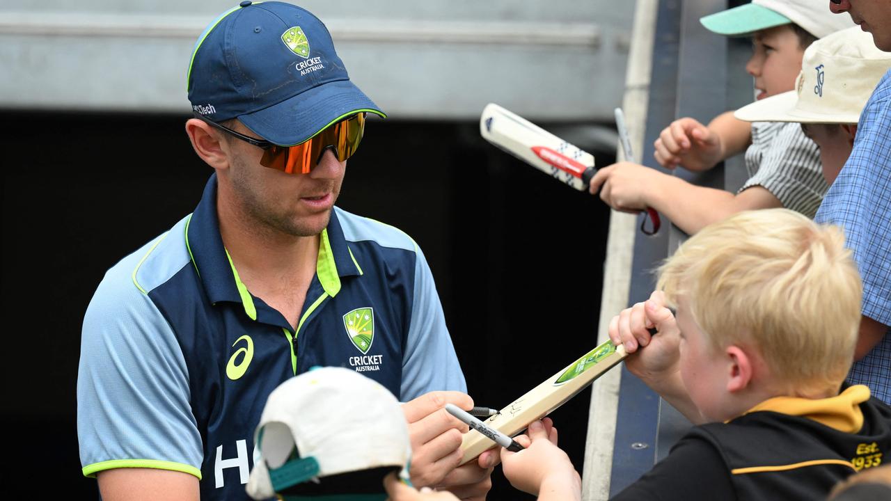 Australia's Josh Hazlewood gives autographs to fans on day one of the second cricket Test match between Australia and India at the Adelaide Oval in Adelaide on December 6, 2024. (Photo by Michael ERREY / AFP) / -- IMAGE RESTRICTED TO EDITORIAL USE - STRICTLY NO COMMERCIAL USE --