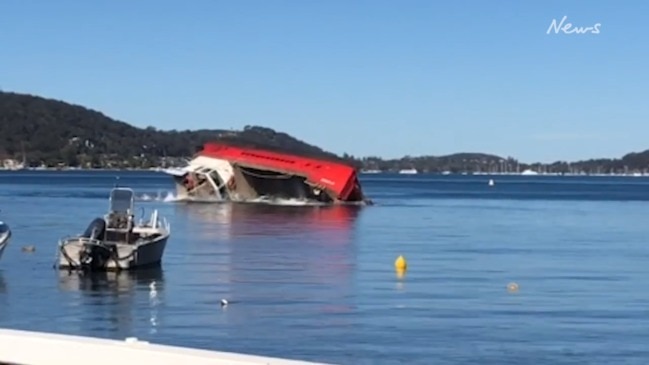 Barge with wastewater truck overturns in Pittwater