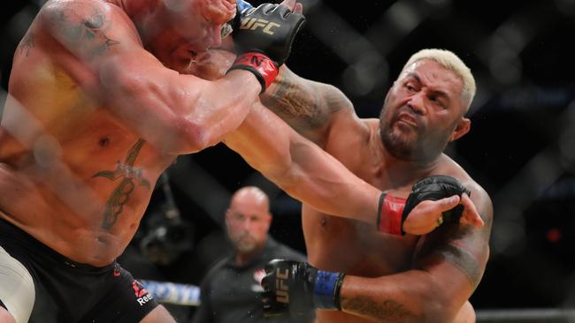 Mark Hunt punches Brock Lesnar during UFC 200.