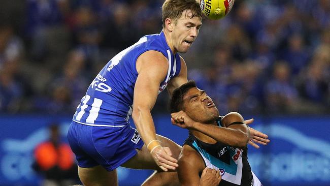 Jake Neade fires off a handball under pressure on Saturday. Picture: Graham Denholm/AFL Media/Getty Images